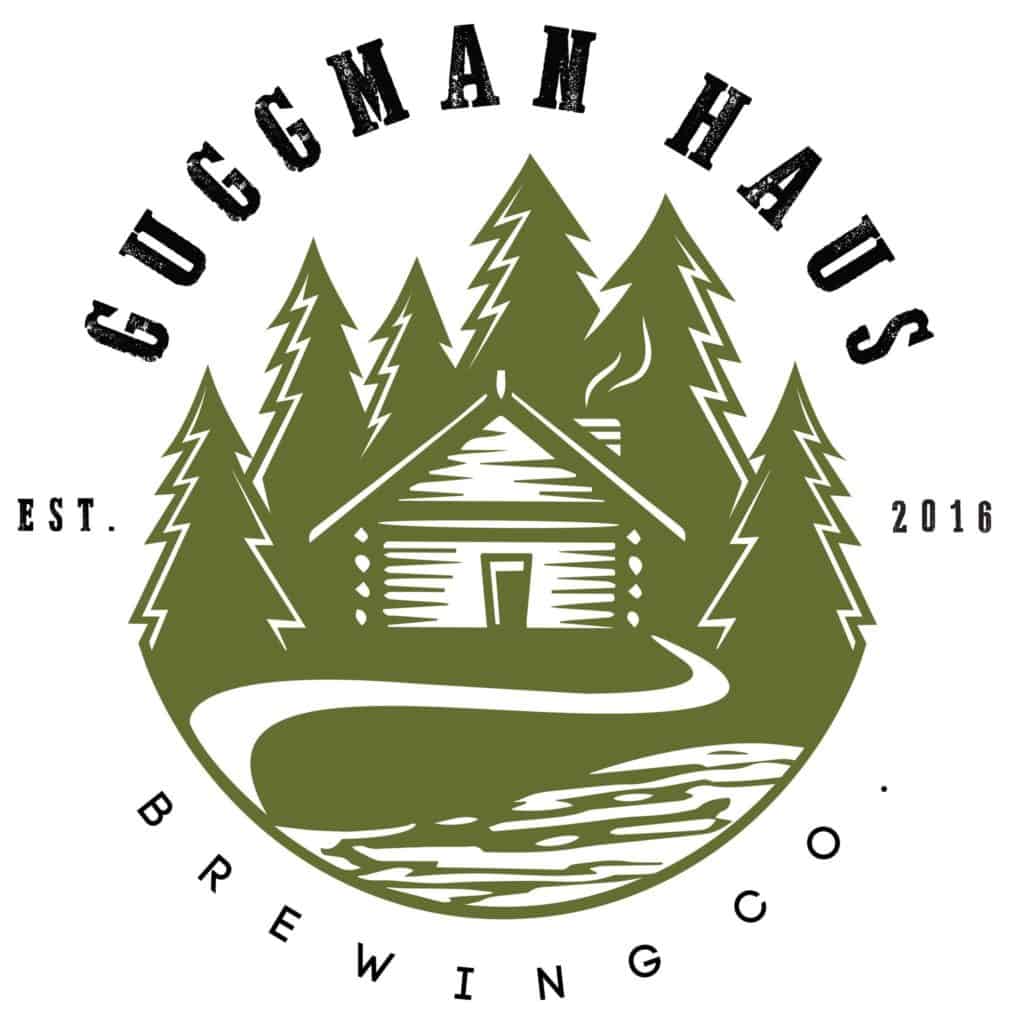 Guggman Haus Logog Featuring a cabin surrounded by pine trees