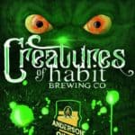 Green creature with yellow eyes with Creatures of Habit Brewing Co