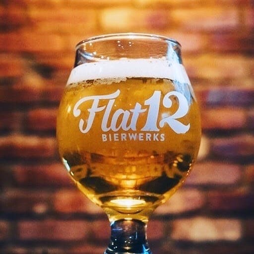 Flat 12 Beer Snifter full of a pale beer